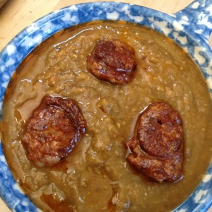 A bowl of creamy lentil soup with chorizo croutes